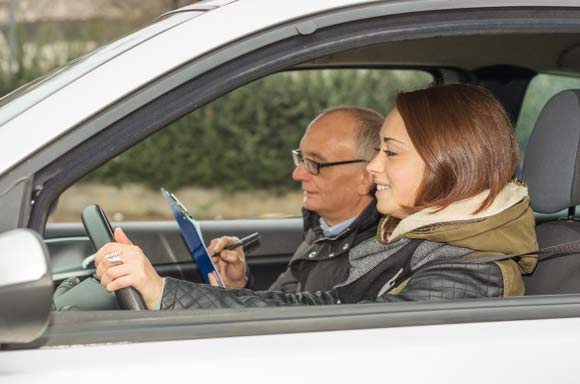 Girl rides during his driving test - caucasian people - Lifestyle and driving school concept